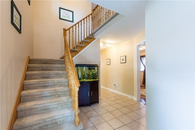 Original foyer with oak staircase and ceramic floor